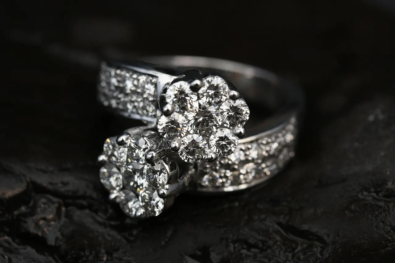 A diamond-studded ring on a black surface