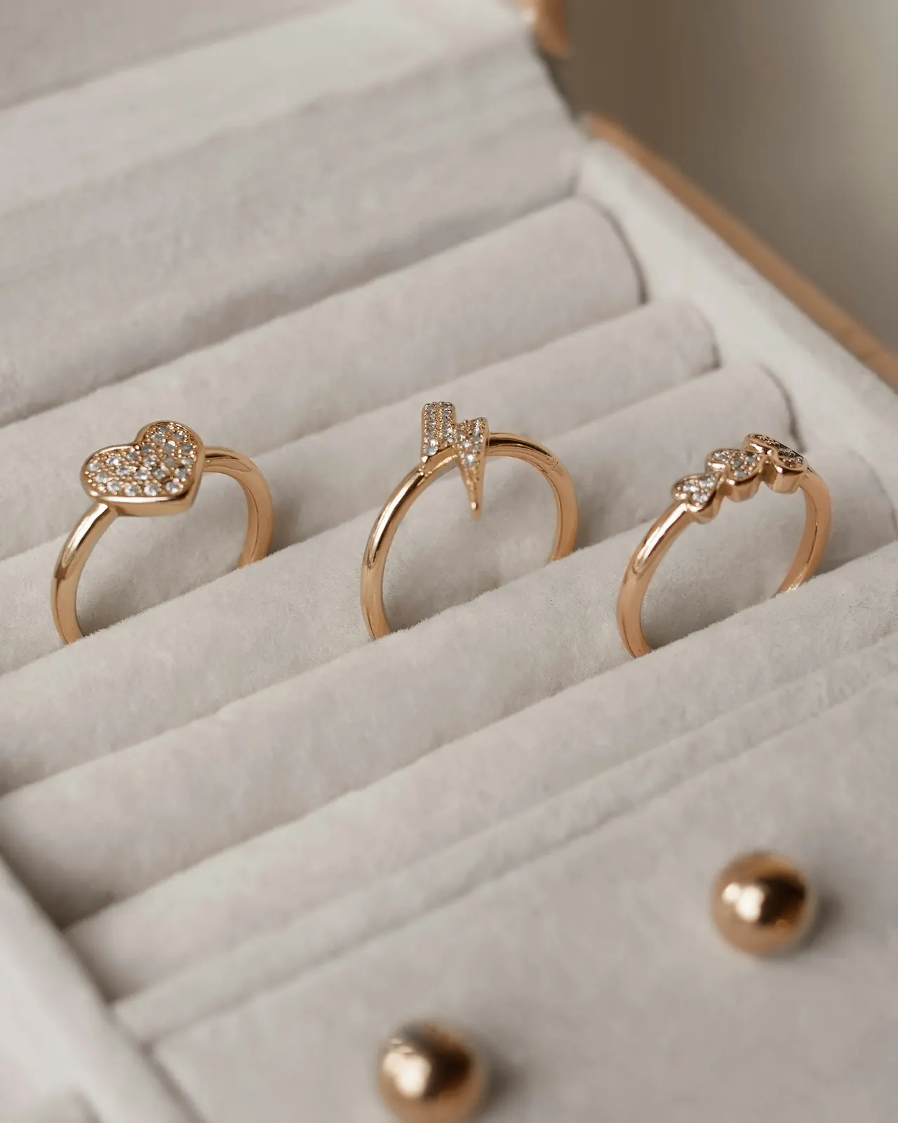 Three gold rings resting in a white box